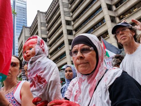 IS SOMEBODY GETTING THEIR JOLLIES WATCHING POLICE PUMMELLED BY DEMONSTRATORS